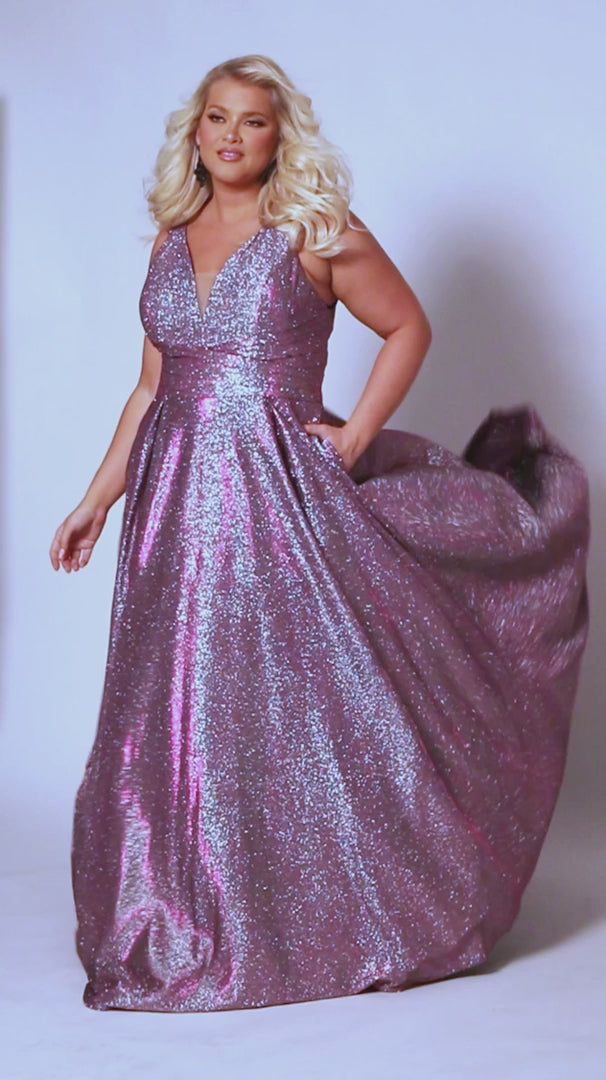 The Sydneys Closet SC7378 Long Prom Dress is perfect for plus size women who want to make a statement. With its V-neckline, A-line silhouette, and two side pockets, this formal gown is sure to turn heads. Crafted from high-quality materials for a comfortable fit, this dress is ideal for special events like proms and pageants. Look no further than our Secret Treasure plus size evening gown to look glamorous at Prom 2024 or the next formal occasion coming up on your calendar.  