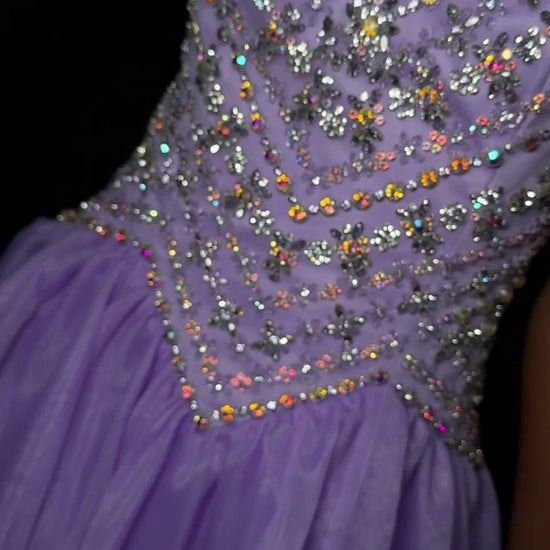 Ashley Lauren 12047&nbsp; Make a grand entrance with ASHLEYlauren Style 12047, an exquisite organza ball gown featuring a fully beaded fitted bodice and a voluminous flowing skirt. Available in Orchid, Red, Ivory, and Royal, this gown is perfect for proms, pageants, and formal events.