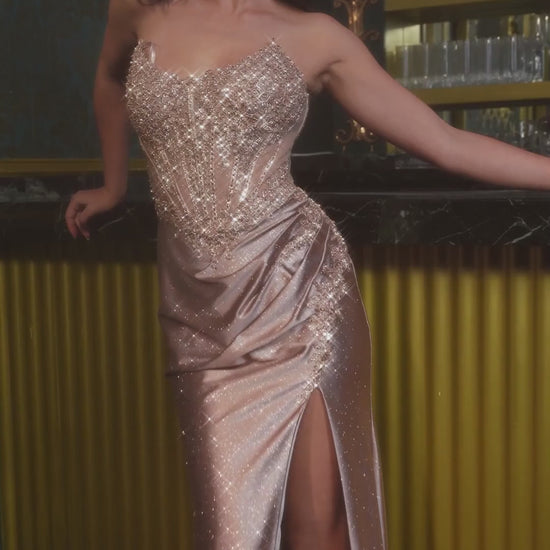 Elevate your prom night with the Ladivine CC475, a stunning beaded corset gown designed to command attention. This sophisticated dress features an elegant scoop neckline and intricate beading throughout the bodice, creating a luminous focal point. The structured corset provides flattering support and definition, while the dramatic slit adds movement and modern edge. A lace-up back detail offers both visual interest and adjustable fit. Perfect for those seeking a show-stopping formal look with refined crafts