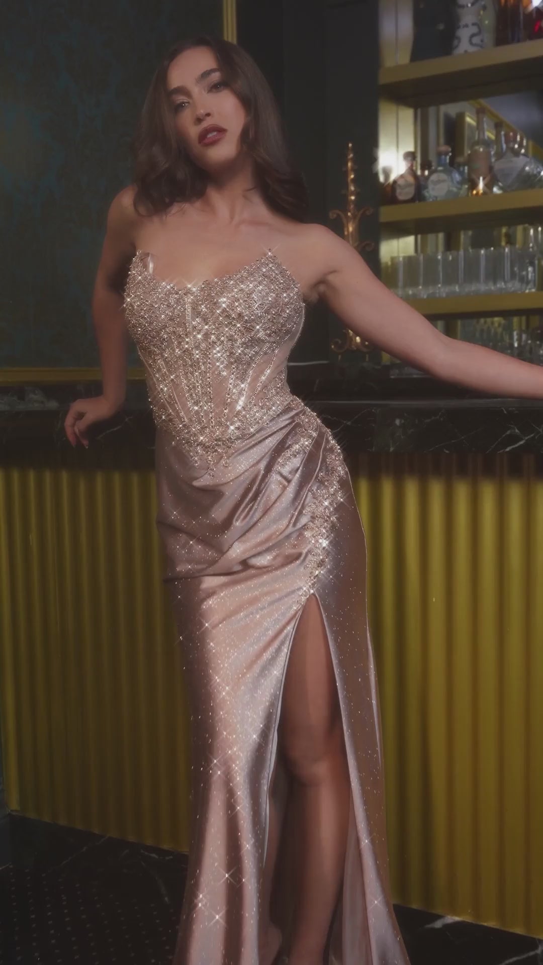 Elevate your prom night with the Ladivine CC475, a stunning beaded corset gown designed to command attention. This sophisticated dress features an elegant scoop neckline and intricate beading throughout the bodice, creating a luminous focal point. The structured corset provides flattering support and definition, while the dramatic slit adds movement and modern edge. A lace-up back detail offers both visual interest and adjustable fit. Perfect for those seeking a show-stopping formal look with refined crafts