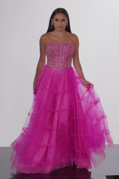Introducing the Jovani 26011, an enchanting prom dress that embodies grace and elegance, perfect for formal occasions. Crafted from delicate tulle, this gown showcases a classic A-line silhouette that exudes timeless beauty. The dress features a beautifully beaded bodice, adding a touch of sparkle and sophistication to your look. The beads glisten under the lights, enhancing the radiance of your presence as you dance the night away.