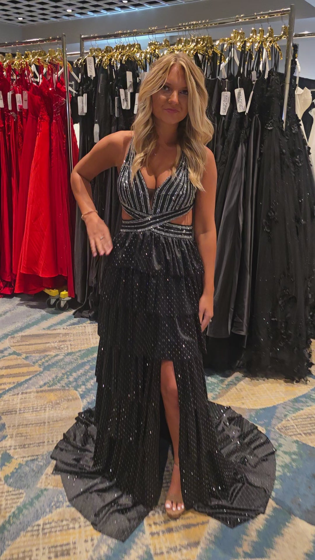Nina Canacci's 9200 is a show-stopping pageant gown that combines elegance with contemporary flair. The crystal-layered jersey skirt features intricate micro crystal embellishments that catch light beautifully, while strategic side cutouts add modern sophistication. A dramatic maxi slit and flowing train create movement and grandeur, making this dress ideal for prom, pageants, and formal competitions. The jersey construction ensures comfortable wear throughout the evening while maintaining a polished silhou