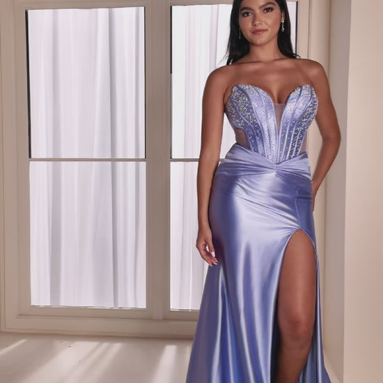 The Ellie Wilde EW37039 combines sophisticated elegance with modern design details. This fitted prom gown features a striking cut-out corset bodice adorned with intricate beading that catches light beautifully throughout the evening. The sheer beaded elements add dimension and glamour while maintaining a refined silhouette. A graceful slit provides movement and contemporary flair. Expertly tailored for a flattering fit, this dress delivers the polished, show-stopping look perfect for prom night or formal ev