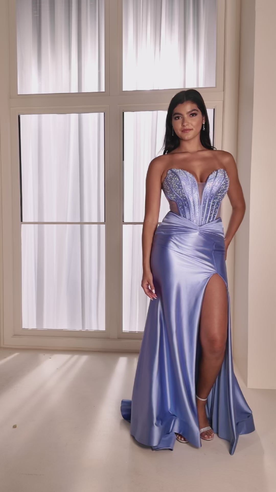 The Ellie Wilde EW37039 combines sophisticated elegance with modern design details. This fitted prom gown features a striking cut-out corset bodice adorned with intricate beading that catches light beautifully throughout the evening. The sheer beaded elements add dimension and glamour while maintaining a refined silhouette. A graceful slit provides movement and contemporary flair. Expertly tailored for a flattering fit, this dress delivers the polished, show-stopping look perfect for prom night or formal ev