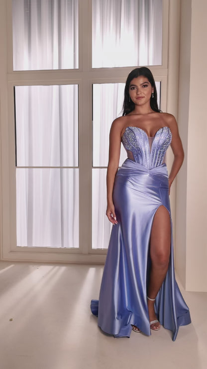 The Ellie Wilde EW37039 combines sophisticated elegance with modern design details. This fitted prom gown features a striking cut-out corset bodice adorned with intricate beading that catches light beautifully throughout the evening. The sheer beaded elements add dimension and glamour while maintaining a refined silhouette. A graceful slit provides movement and contemporary flair. Expertly tailored for a flattering fit, this dress delivers the polished, show-stopping look perfect for prom night or formal ev