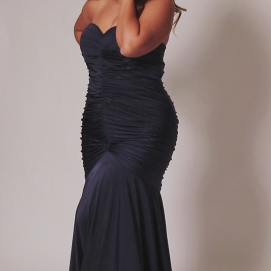 Make a statement in this luxurious Sydneys Closet SC7374 prom dress. This long, fitted gown is crafted in a mermaid silhouette, with a strapless neckline, ruching from the waistline to the floor, and a statement train. Perfect for plus size formal occasions. Look glamorous at Prom 2024 or any dressy event when you wear our Simply Ravishing plus size formal Mermaid gown. 