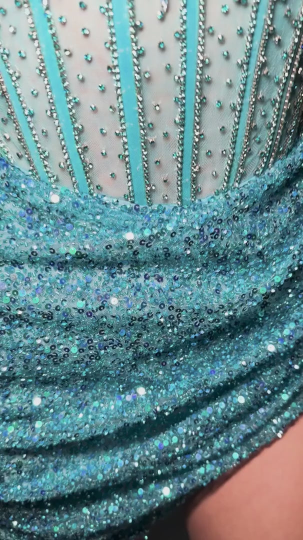 Elevate your evening with the Ashley Lauren 4564 cocktail dress, featuring intricate sequin beading that catches the light with every movement. This short homecoming gown combines a structured corset silhouette with sheer detailing for a refined and alluring look. Perfect for special occasions, it offers a sophisticated blend of glamour and elegance to make a memorable statement.&nbsp;Ashley Lauren 4564&nbsp;Strapless cocktail dress beaded with exposed boning. The wrap sequin skirt completes the look.

Stra