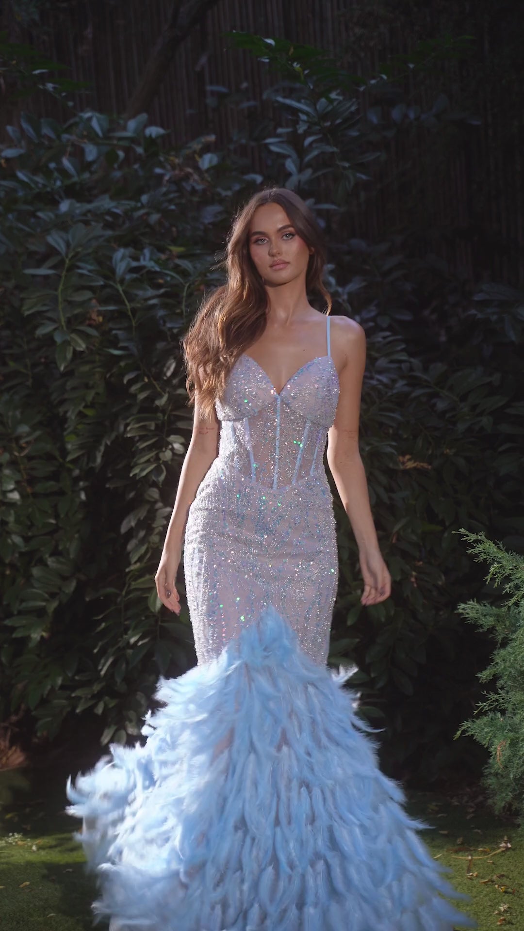 Get ready to turn heads in this stunning Andrea & Leo Couture A1298 dress. With a sheer corset bodice and glittering feather details, this mermaid prom dress is sure to make a statement. The perfect choice for any formal event, you'll feel confident and glamorous all night long. 