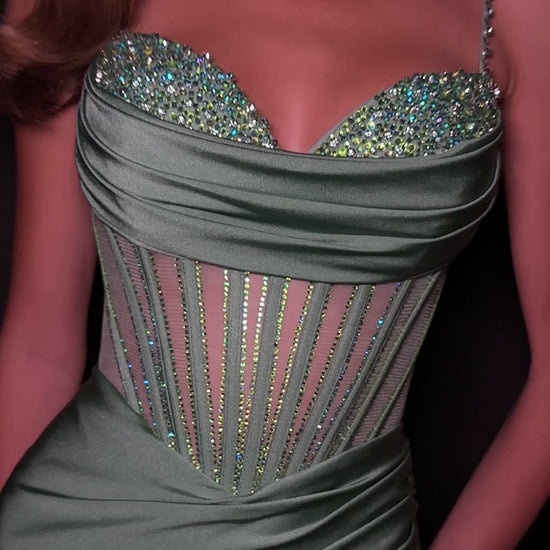 Step into sophistication with this sleek and elegant jersey gown, ASHLEYlauren Style 12173. Featuring a beaded bustier-style bodice with delicate spaghetti straps, this fitted dress highlights your figure with a ruched waist and flattering draped skirt. The corset detailing adds structure and sparkle, while the sweeping train ensures a glamorous finish. Perfect for prom, pageant, or any formal event, this gown brings modern allure and timeless elegance together.

Available in Emerald, Purple, Red, Black, Fu