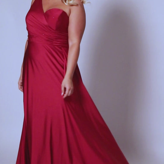 Experience elegance and glamour in the SC7377 gown from Sydneys Closet. This A-line over skirt dress features a one shoulder strap, perfect for your next special event or formal occasion. The full train adds a beautiful and regal finish to the look. Plus size available for up to size 24. Get ready to be the woman who turns heads at Prom 2024 or any special occasion evening event in the Simple and Sophisticated formal dress designed by Sydney's Closet.
