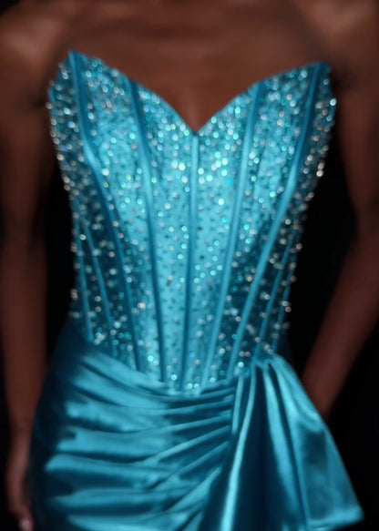 The ASHLEYlauren Style 12240 exemplifies contemporary formal wear design with its expertly engineered silhouette. This fitted gown features a strapless sweetheart bodice with precision ruching that creates dimensional shaping, paired with a luxurious shimmer jersey fabric that provides both structure and movement