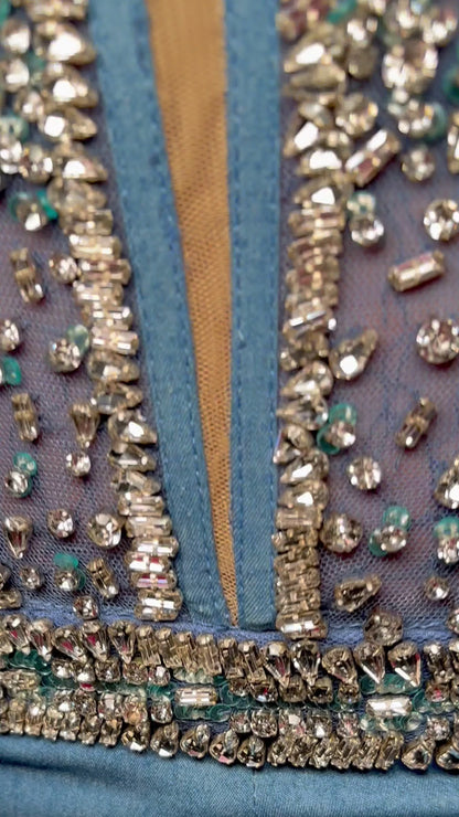 Elevate your formal attire in the Ashley Lauren 11513 Denim Jumpsuit. Beaded bustier and corset provide a flattering silhouette. The ombre feather design adds a touch of elegance. Perfect for prom or any formal event. Expertly crafted for a sophisticated and stylish look. Can you say iconic? This denim jumpsuit features a fully beaded bustier and waist band. The style is complete with ombre feather details and off shoulder feathered straps.