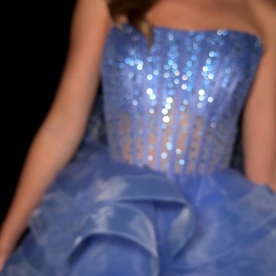 Elevate your evening with the Ashley Lauren 4883, a short fit-and-flare cocktail gown featuring delicate ruffle layers and a sheer corset bodice. This homecoming dress combines elegance and modern design, offering a flattering silhouette that enhances your natural shape. Perfect for special occasions, its intricate details and graceful flow ensure you stand out with timeless sophistication. Make a statement in this stunning ASHLEYlauren Style 4883 mini dress. Featuring a fully boned corset-style bodice with