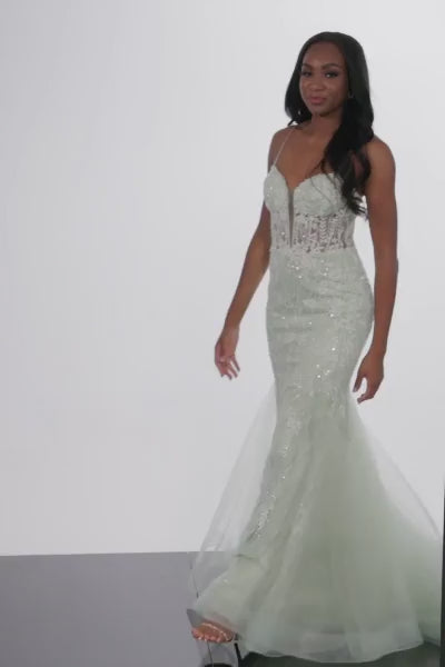 This elegant Jovani 37414 long prom dress is designed with a sheer corset and mermaid silhouette, making it the perfect choice for special occasions. The fitted bodice and sequin fabric add a touch of glamorous style, while the sleek silhouette flatters the figure. Look and feel your best in this dreamy formal gown.  Sizes: 00-24  Colors: Mint, Lilac