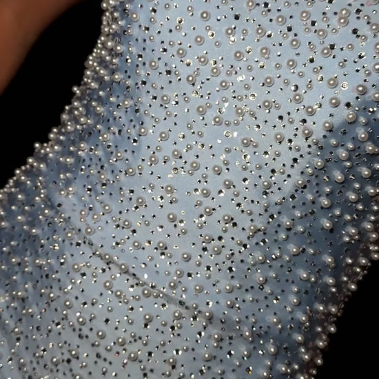 Elevate your special occasion with the Ashley Lauren 4715 Short Crystal Pearl Cocktail Dress. This mini homecoming dress features a graceful scoop neck and delicate crystal pearl embellishments, offering a refined and elegant silhouette. Perfect for receptions or cocktail events, its sophisticated design ensures you stand out with timeless charm and subtle sparkle. Stun the crowd in this chic strapless cocktail dress. Featuring a stunning neckline and V-neck back, this dress is covered in crystals and pearl