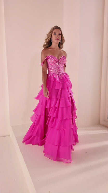 Elevate your prom night in this stunning Ellie Wilde EW37108 gown. Crafted from luxurious chiffon with intricate lace appliqué and shimmering sequin details, this long A-line dress features a sweetheart neckline and sleeveless silhouette for timeless elegance. The structured corset bodice with basque waistline creates a flattering, defined shape, while tiered ruffles add romantic movement. Detachable shoulder straps offer styling versatility, and the lace-up back provides a secure, customizable fit. A taste