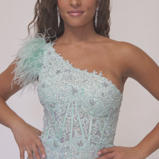 Make a statement at prom with the Abby Paris 90256 dress. This one-shoulder gown features intricate lace and stunning sequin embroidery,. The high slit reveals just the right amount of skin, while the feather detailing adds a touch of glamour. Perfect for a night to remember.  Sizes: 0-18  Colors: Mint, Lilac