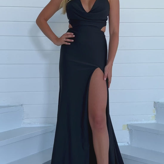 This Ava Presley formal prom dress (style 39271) features a Cowl Neck, cut-out detailing, and a high slit. Made with high-quality jersey material, the Long Gown design is perfect for any formal event. Elegantly designed, this dress exudes sophistication and glamour, capturing attention and making a statement at any occasion.