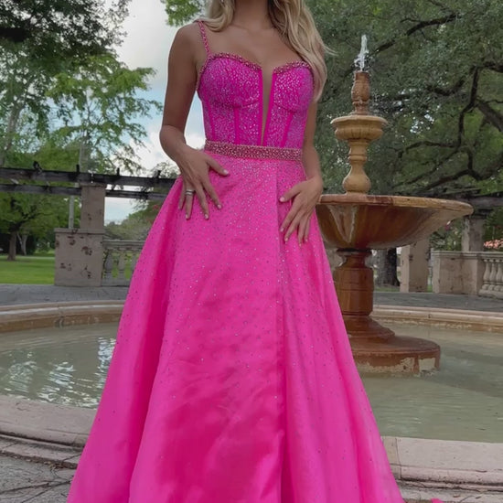 This Ava Presley 28581  long prom dress features a fitted corset and plunging V neckline, adorned with intricate beaded detailing. Perfect for formal occasions and pageants, this gown is designed to flatter and enhance your figure. Make a statement and turn heads with this stunning piece.