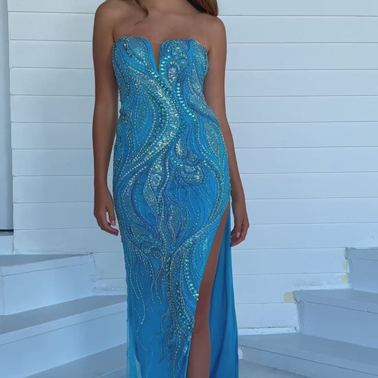 This Ava Presley 39219 long prom dress exudes elegance and sophistication. The fitted silhouette, strapless design, and sweetheart neckline beautifully showcase your figure, while the intricate beaded detailing adds a touch of glamour. With a high slit and formal pageant gown style, this dress is perfect for any special occasion.