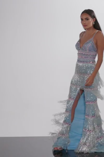 Make a statement in Jovani’s 38846 prom dress, crafted with sequin-beaded fringe detailing and a fitted tulle silhouette. The style features a beaded bodice and spaghetti strap V neckline, plus a dramatic open tie-back and sweeping train. The skirt showcases a high slit and beaded fringe design, completing the look.   Sizes: 00-24  Colors: Light Blue
