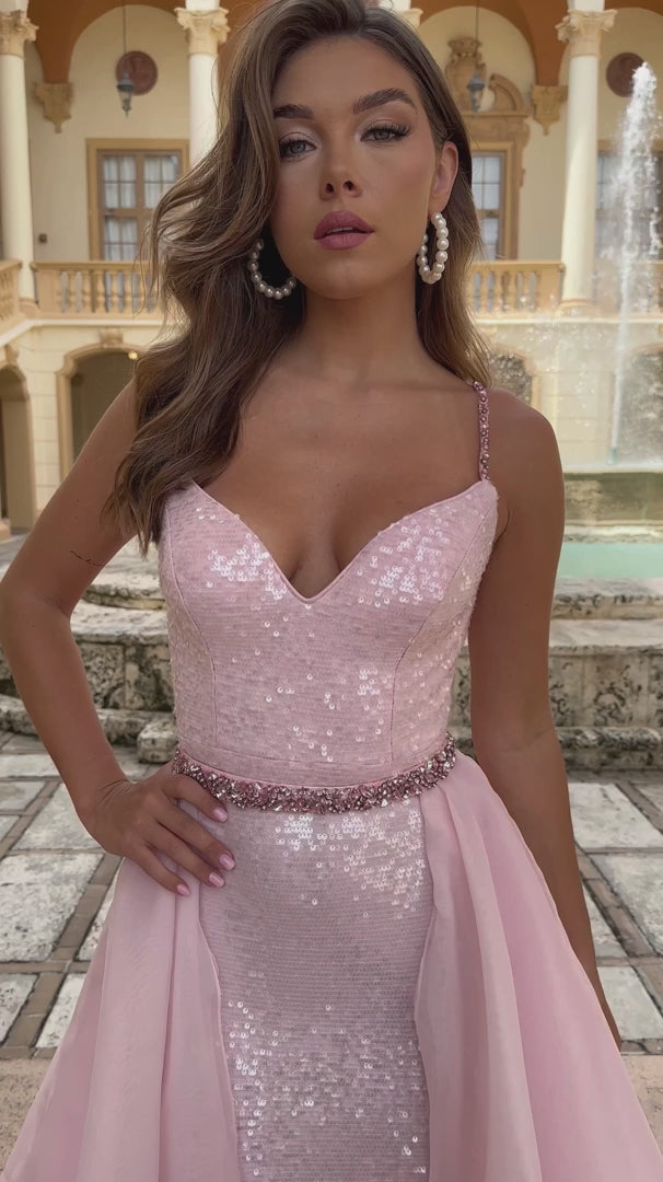 Look stunning in the Ava Presley 28560 Long Sequin Gown. With a removable organza skirt, this dress is perfect for prom or formal pageants. The sequin detailing adds a touch of glamour while the removable skirt allows for versatility in styling. Make a statement with this elegant and sophisticated gown.