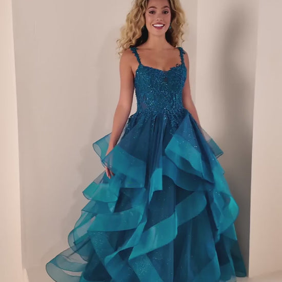 Elevate your prom night with this stunning Ellie Wilde ballgown. The EW37128 features a structured corset bodice and voluminous ruffle skirt in a captivating teal hue. This Size 0 gown combines timeless elegance with dramatic flair, perfect for making an unforgettable entrance. The fitted corset provides support and definition while the cascading ruffles create movement and dimension. Ideal for prom, formal events, or any occasion calling for show-stopping glamour.

Size: 0

Color: Teal