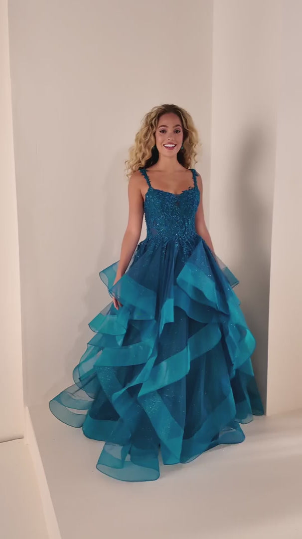 Elevate your prom night with this stunning Ellie Wilde ballgown. The EW37128 features a structured corset bodice and voluminous ruffle skirt in a captivating teal hue. This Size 0 gown combines timeless elegance with dramatic flair, perfect for making an unforgettable entrance. The fitted corset provides support and definition while the cascading ruffles create movement and dimension. Ideal for prom, formal events, or any occasion calling for show-stopping glamour.

Size: 0

Color: Teal