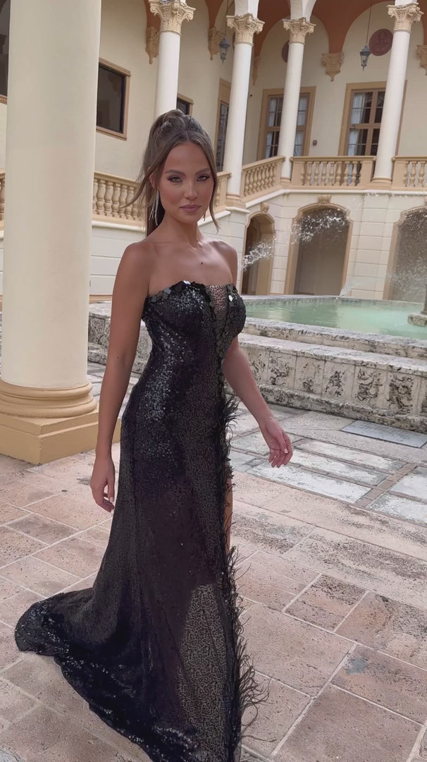 Dazzle in the Ava Presley 28573 Long Prom Dress. This stunning gown features intricate beading, a cut glass detail, and a dramatic high slit. The feather trim adds a touch of elegance to this formal pageant dress. Elevate your look and make a statement at your next event.