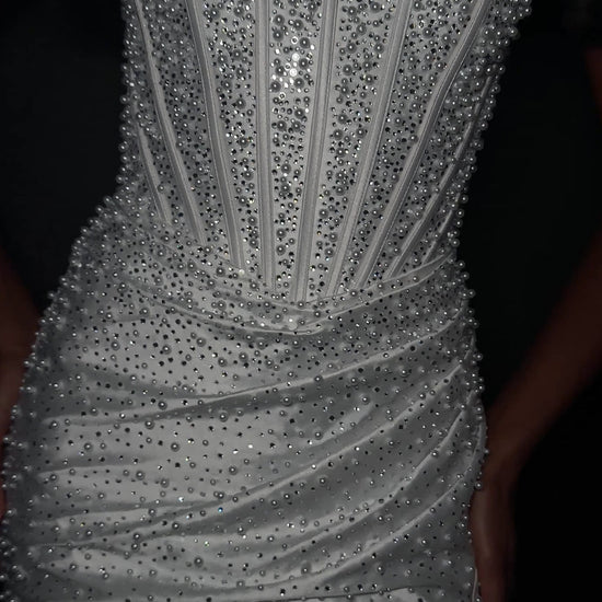 ASHLEYlauren Style 12356 is a fully beaded evening gown that commands attention with its fitted silhouette and strapless neckline.&nbsp; Ashley Lauren 12356 The expertly contoured bodice features vertical beadwork that accentuates the waist and elongates the figure, while a sweeping train with slit adds dramatic movement. Crafted from jersey fabric with pearl corset bustier detailing, this gown delivers high-impact sparkle from every angle. Ideal for pageants, red carpet events, prom, galas, and special occ