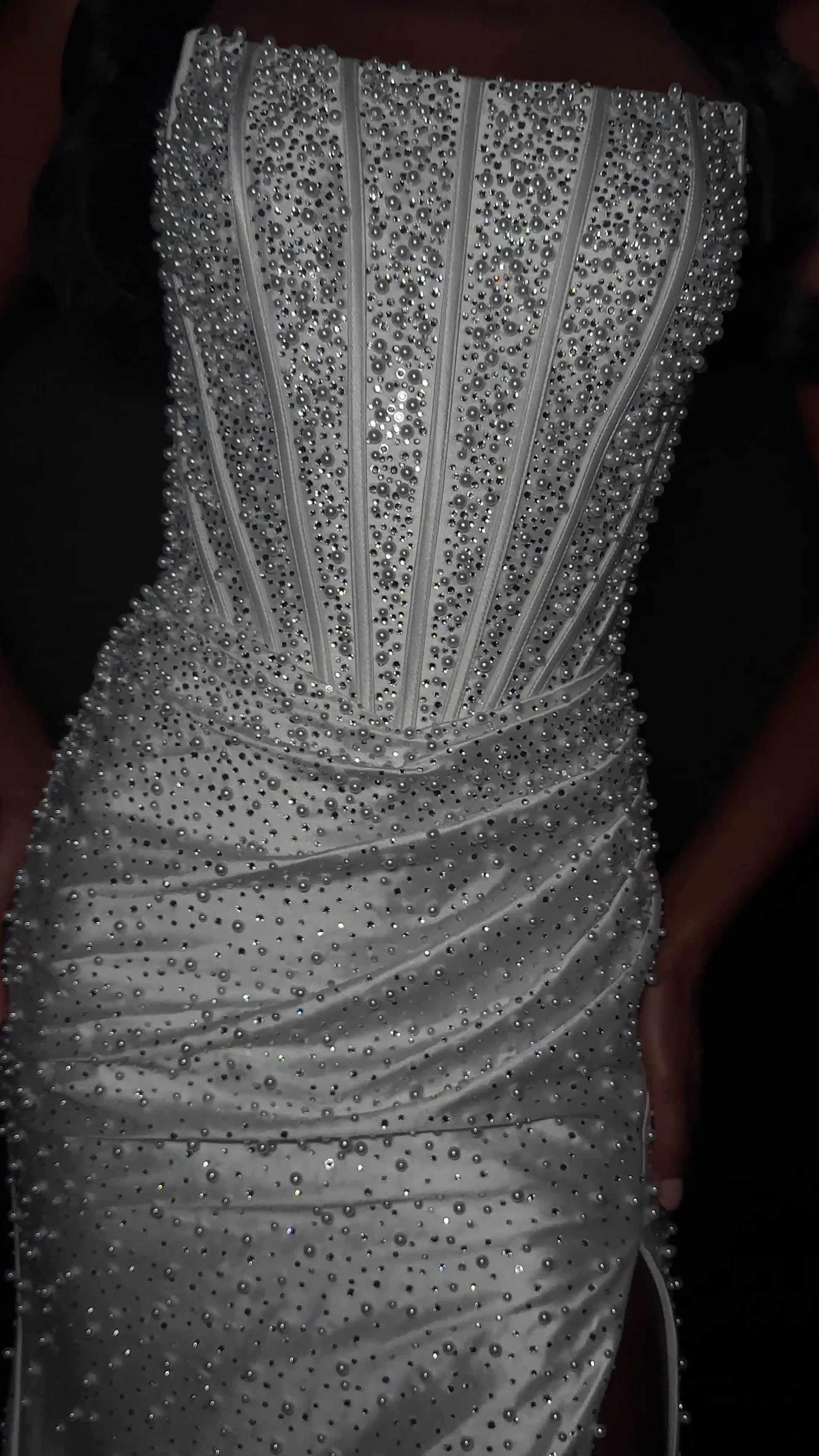 ASHLEYlauren Style 12356 is a fully beaded evening gown that commands attention with its fitted silhouette and strapless neckline.&nbsp; Ashley Lauren 12356 The expertly contoured bodice features vertical beadwork that accentuates the waist and elongates the figure, while a sweeping train with slit adds dramatic movement. Crafted from jersey fabric with pearl corset bustier detailing, this gown delivers high-impact sparkle from every angle. Ideal for pageants, red carpet events, prom, galas, and special occ