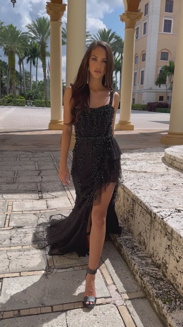 Expertly crafted by the renowned designer, Ava Presley, this long prom dress features exquisite beading and a stunning ruffled organza train with delicate feather accents. The high slit adds a touch of allure, making it the perfect choice for any formal event or pageant. Elevate your style with this one-of-a-kind gown.