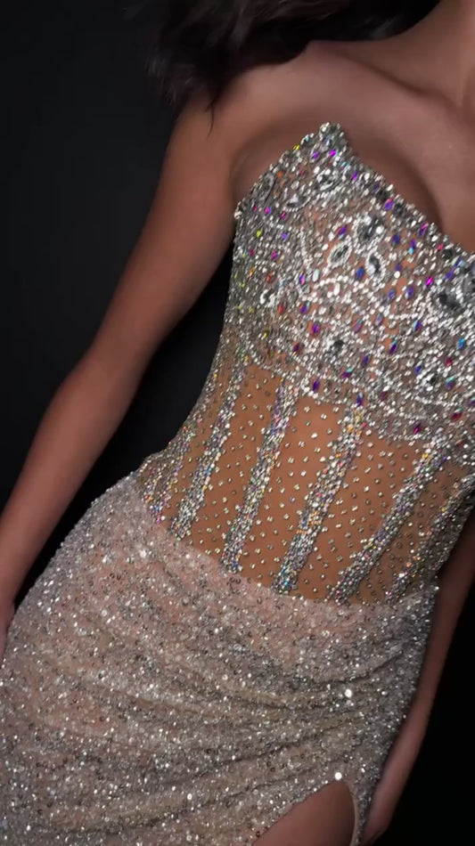 The Ashley Lauren 11830 Prom Dress is a stunning choice for any formal occasion. Adorned with sequins and sheer crystal detailing, this strapless corset gown exudes elegance and luxury. The slit adds a touch of allure while the corset provides a flawless fit. Perfect for making a statement on any red carpet event or pageant stage.&nbsp;Dazzle in this fully beaded gown. The sweetheart neckline is complete with a corset bustier. The skirt is finished with horsehair and a left leg slit.

Sweetheart Neckline