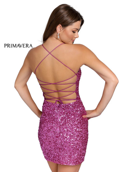 Primavera 3351 is a short fitted sequin embellished cocktail dress. This gown would be perfect for homecoming, dances & Formal events. Scoop neckline with spaghetti straps wrapping around to an open back with a lace up corset tie. This backless dress features multi Red & Textured sequins for Tons of Dimension!