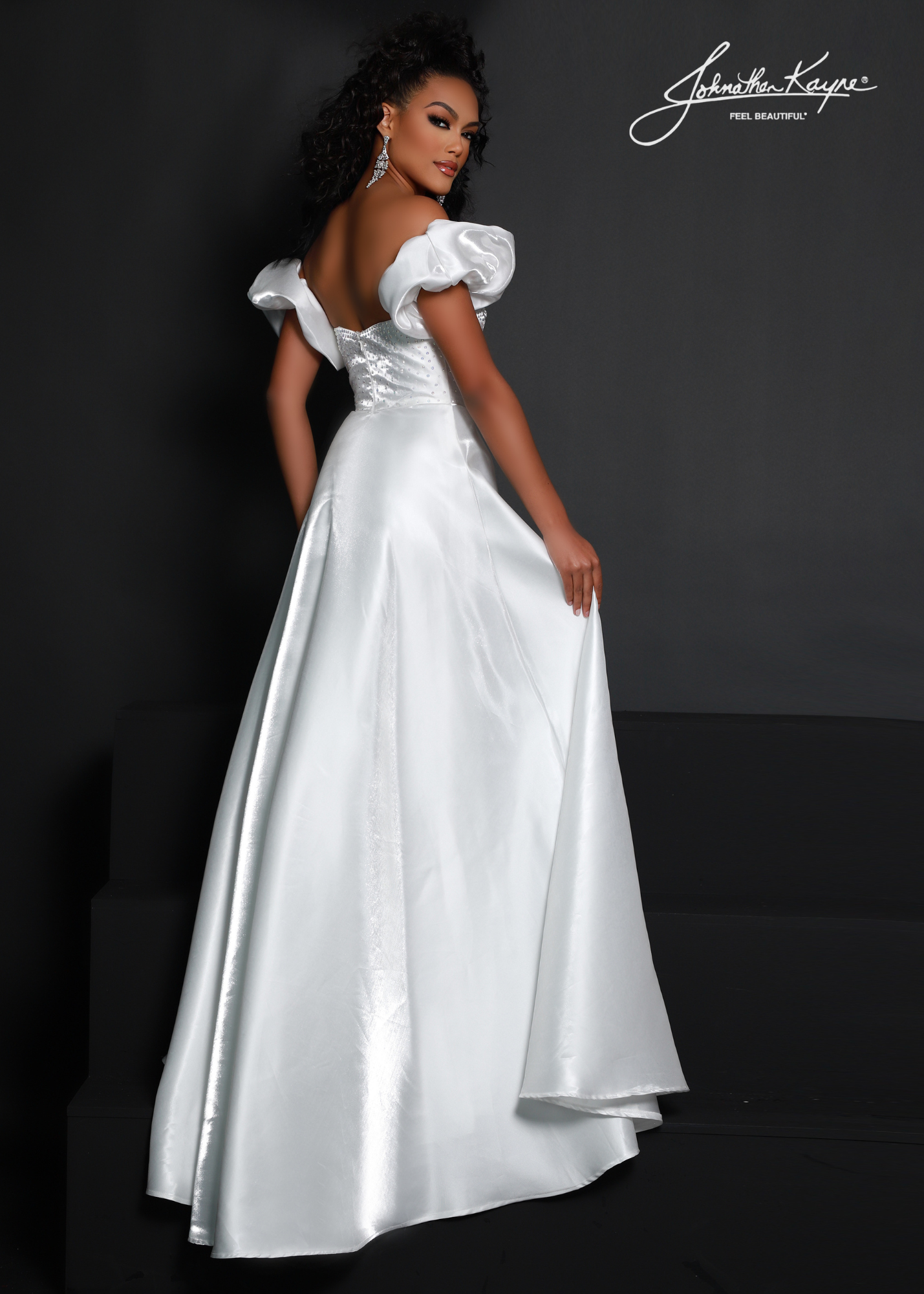 Make a statement in this Johnathan Kayne 2642 dress! Made of luxurious White Shimmer satin, its A-line silhouette and puff sleeves will have you looking fabulous for any formal occasion. With a high slit for extra pizzazz, you won't be able to resist this elegant maxi dress! Shake things up in style! Show off your style and sophistication in this beautiful shimmer satin A-line gown with removeable puff sleeves at any event  Size: 2  Color: White