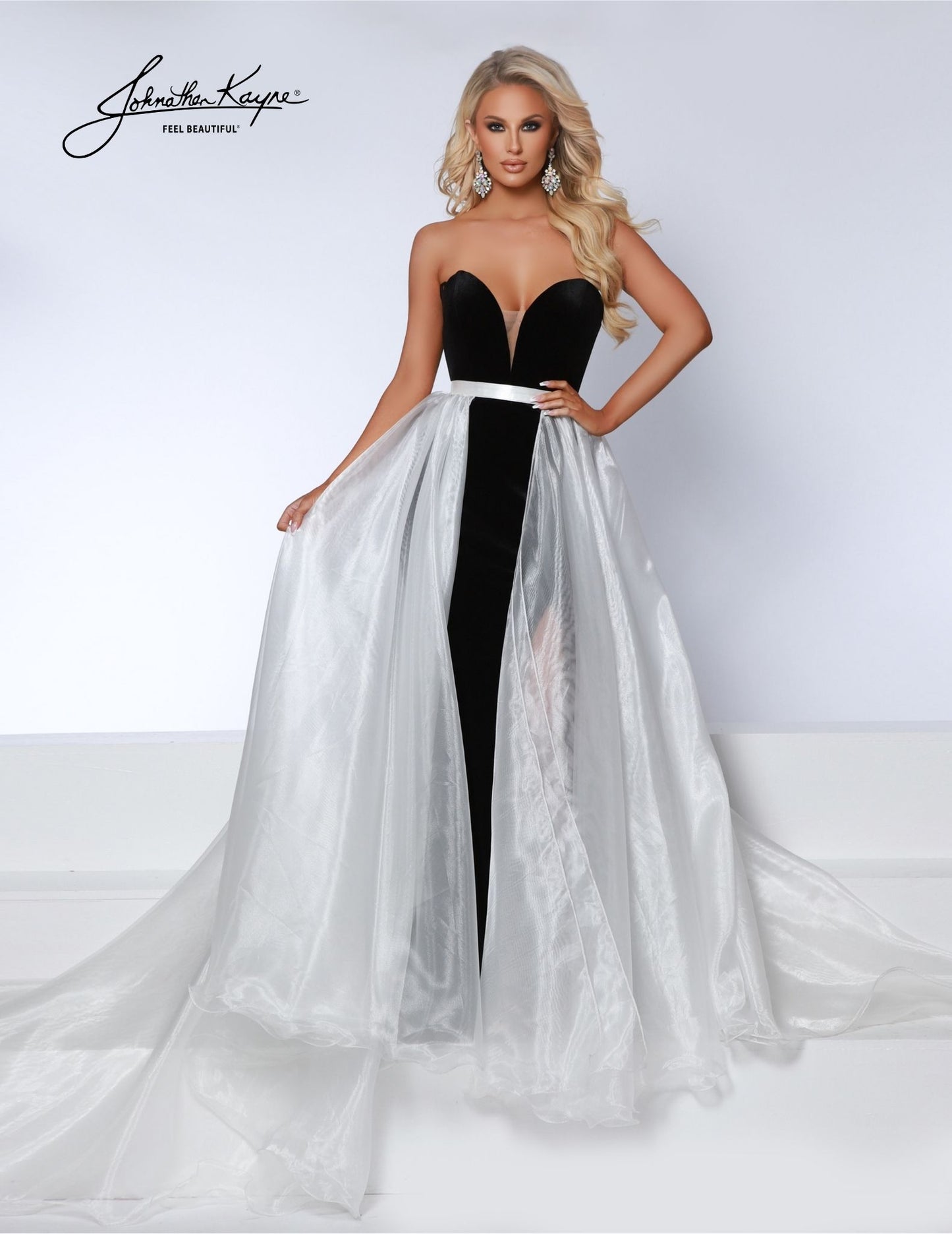 Experience the versatility of the Johnathan Kayne Detachable Overskirt. Designed with organza fabric and a wire hem, this formal wear accessory adds a touch of glamour to any pageant or special event. Transform your look with the detachable feature and elevate your style game. A true wardrobe essential, this poly organza overskirt allows you to personalize your look for various occasions. Whether paired with a gown, a cocktail dress, or even a casual ensemble, it adds an instant dose of elegance and flair.