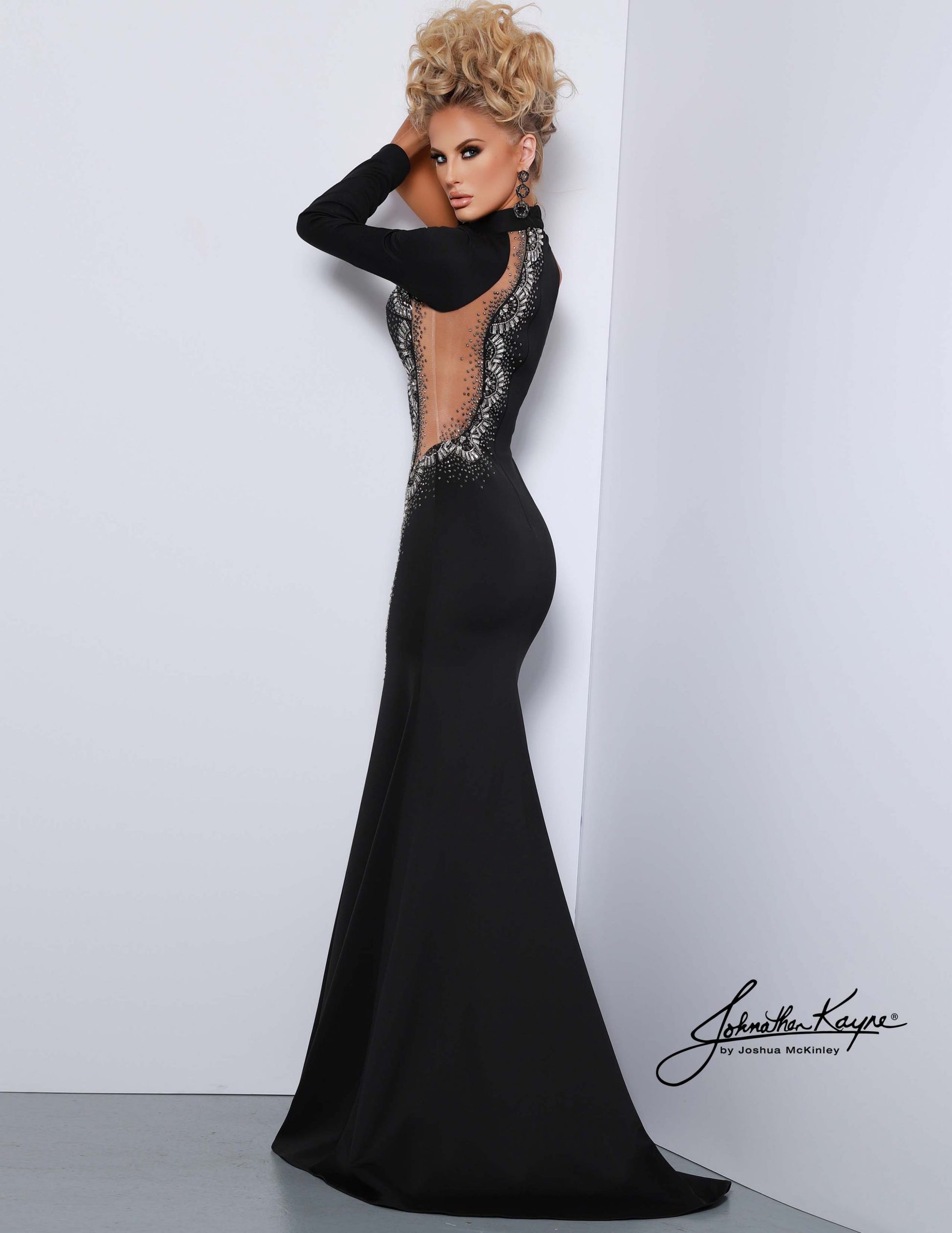 Johnathan Kayne 2421 Size 4 Black Long Sheer One Shoulder Long Sleeve Pageant Dress Formal Gown. This elegant and sophisticated gown is crafted from sheer fabric and features a one-shoulder sleeve in a size 4. This beautiful evening dress is ideal for a formal event or pageant. With subtle detailing, it is sure to make heads turn.
