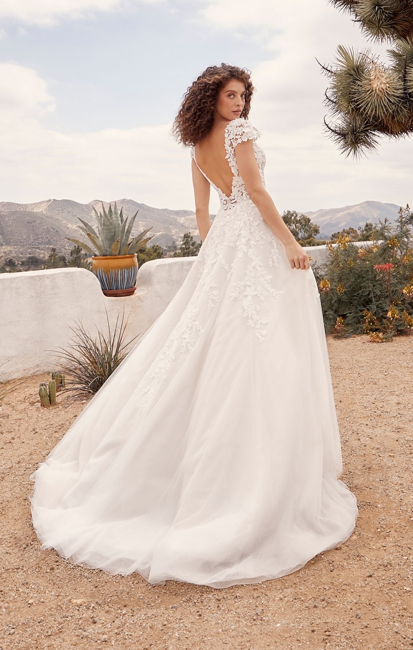 Casablanca Beloved BL435Rusty A-Line Low Back Cap Sleeves V-Neck 3D Appliques Floral Embroidered Train Wedding Gown. Embodying all things romance, Rusty is for the bride who wants to feel like she’s floating on cloud nine. Her A line shape with layers of organza, beaded floral lace and luxurious lining make this dress so divine to wear. 