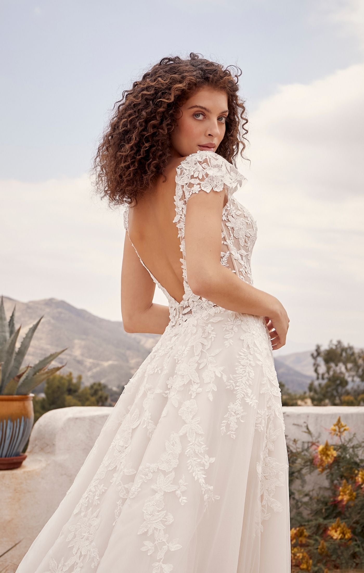 Casablanca Beloved BL435Rusty A-Line Low Back Cap Sleeves V-Neck 3D Appliques Floral Embroidered Train Wedding Gown. Embodying all things romance, Rusty is for the bride who wants to feel like she’s floating on cloud nine. Her A line shape with layers of organza, beaded floral lace and luxurious lining make this dress so divine to wear. 