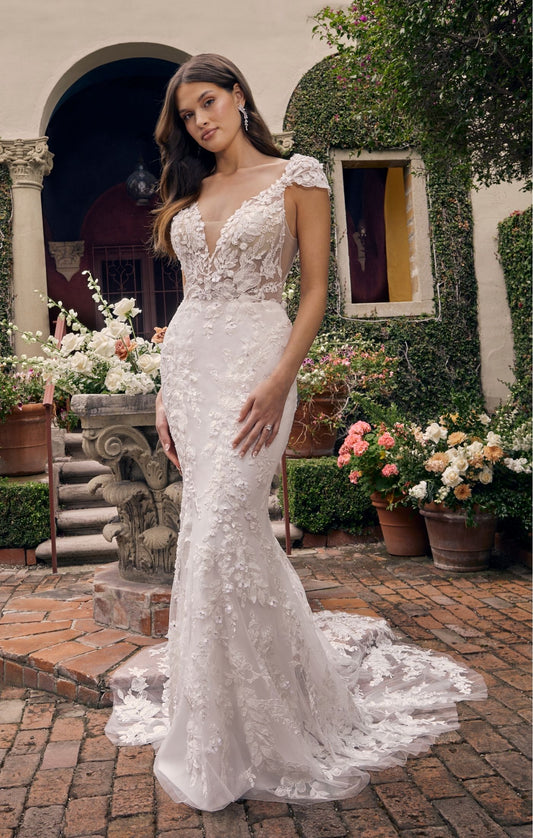 Casablanca Bridal 2543 Delphine Fitted 3D Floral Lace Deep V-Neck Detachable Cap Sleeves Train Wedding Gown. Featuring lovely beading and sequins, all over 3D floral lace throughout the gown adds soft dimension to her look. The sheer bodice is given a subtle plunge at the V-neckline that is perfectly accented with beaded spaghetti straps and detachable cap sleeves (included). The fitted silhouette, paired with a stretchy chiffon lining, will hug and contour your curves.