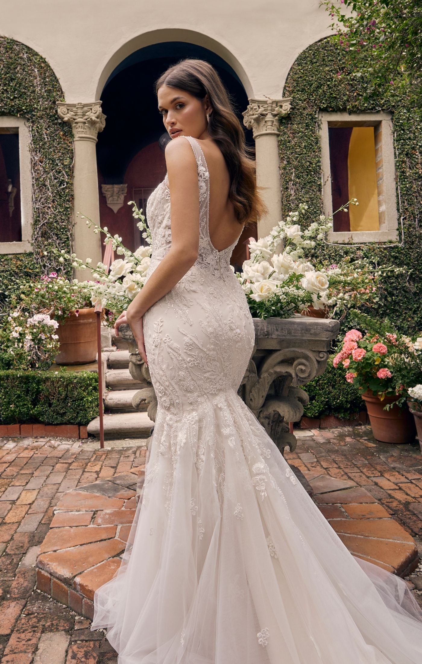 Casablanca Bridal 4546 Sylvie Mermaid Sweetheart Neckline Tulle Floral Lace Train Wedding Gown. Made for every type of body shape, this glittering fit and flare wedding dress is going to hug your curves in the most flattering way. The unique sweetheart and V-neckline gives way to thin straps and a sexy low back. Tonal beaded and sequined lace appliqués run through the entirety of the gown that will glisten into the night. It's complete with a stretch georgette lining and a sheer back.