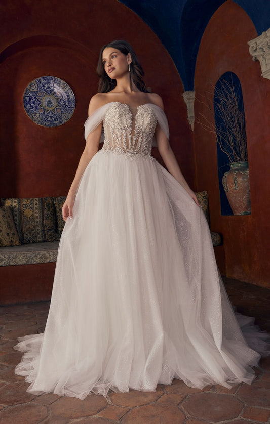 Casablanca Bridal 2547 Meline A-Line Ballgown Sheer Corset Off The Shoulder Plunging Neckline Train Wedding Gown. 2547 is a sparkling sensation, for the bride who wants to glimmer from every angle. This stunning ballgown wedding dress features an intricately beaded illusion bodice, accented by a plunging neckline and detachable off the shoulder, soft tulle straps. From tulle off-shoulder straps, to completely strapless, this versatile gown offers options for a reception change! 
