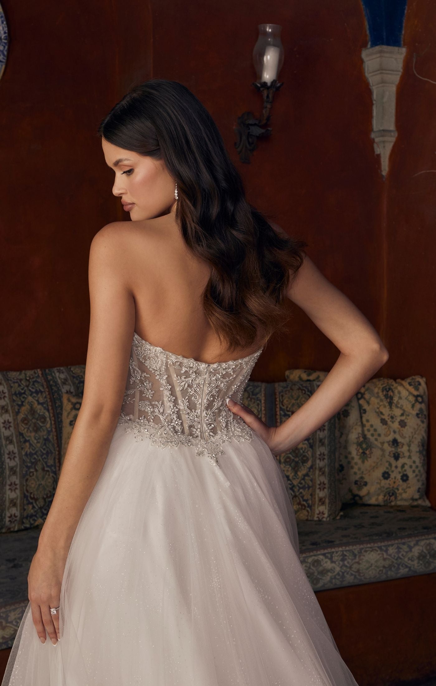Casablanca Bridal 2547 Meline A-Line Ballgown Sheer Corset Off The Shoulder Plunging Neckline Train Wedding Gown. 2547 is a sparkling sensation, for the bride who wants to glimmer from every angle. This stunning ballgown wedding dress features an intricately beaded illusion bodice, accented by a plunging neckline and detachable off the shoulder, soft tulle straps. From tulle off-shoulder straps, to completely strapless, this versatile gown offers options for a reception change!