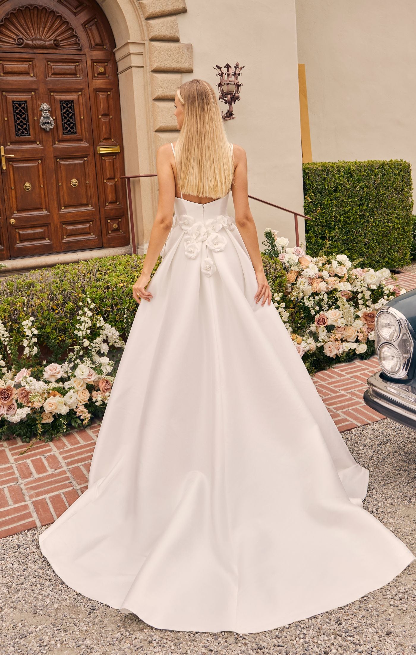 Casablanca Bridal 2556 A-Line Spaghetti Strap V-Neck Slit Train Wedding Gown. Prepare to be captivated by the sheer beauty of Style 2556 Bellisima, an exquisite A-line wedding dress that redefines effortless elegance. The spaghetti strap bodice of Bellisima features a flattering V-neckline, accentuating your décolletage and creating a delicate frame for your face.