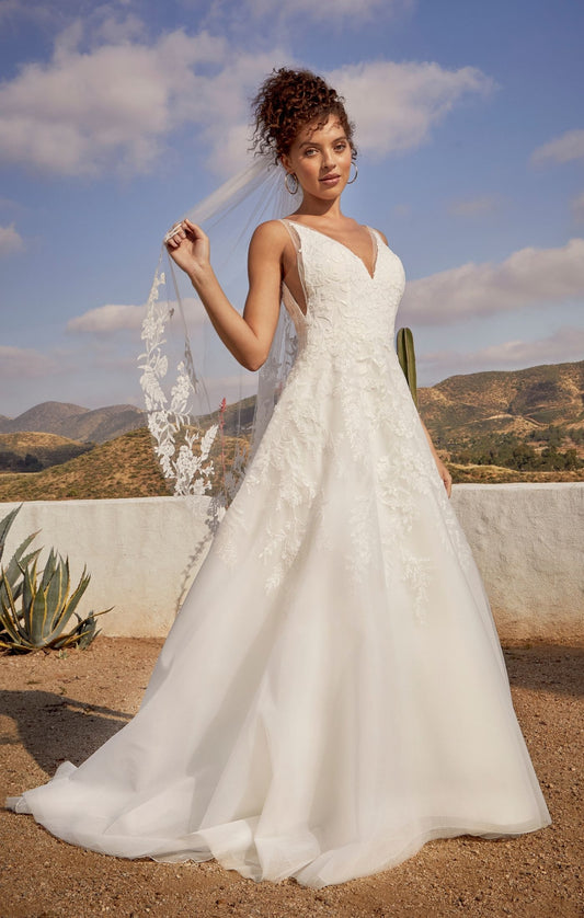 Casablanca Beloved BL431 Janie A-Line Ballgown V-Neck Floral Lace Train Wedding Gown. Reminiscent of storybook romance, exceptionally sweet Style BL431 Janie is a treasure to behold. Crafted with meticulous attention to detail, Janie features a delicate lining that ensures a comfortable fit, allowing you to move with ease. The combination of organza, tulle with floral lace, and sequins creates a breathtaking effect, adding depth and dimension to the gown