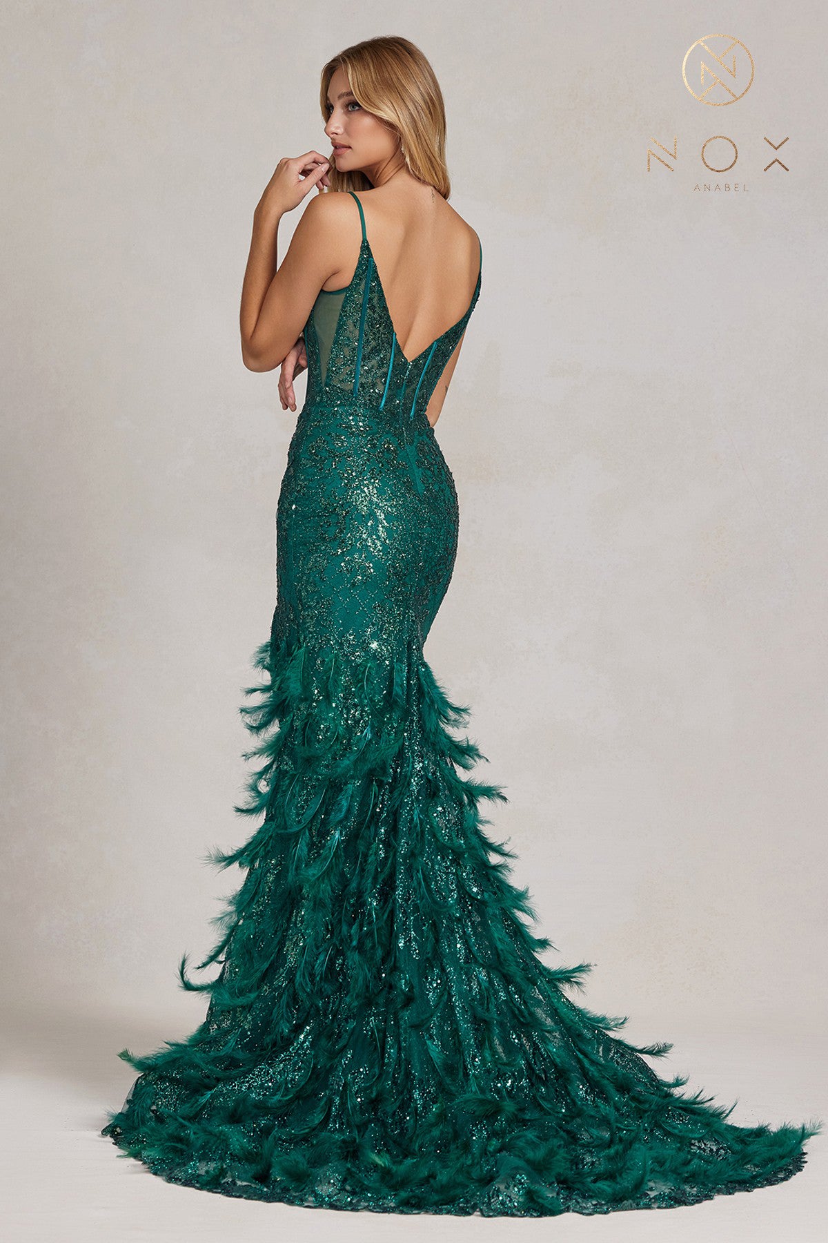 Nox Anabel C1119 Long Sheer Fitted Corset bodice with a v neckline Feather & Sequin embellished Mermaid skirt with a slit Prom Dress Pageant Gown.  Sizes: 00-16  Colors: Black, Emerald, Fuchsia, Royal Blue, Red