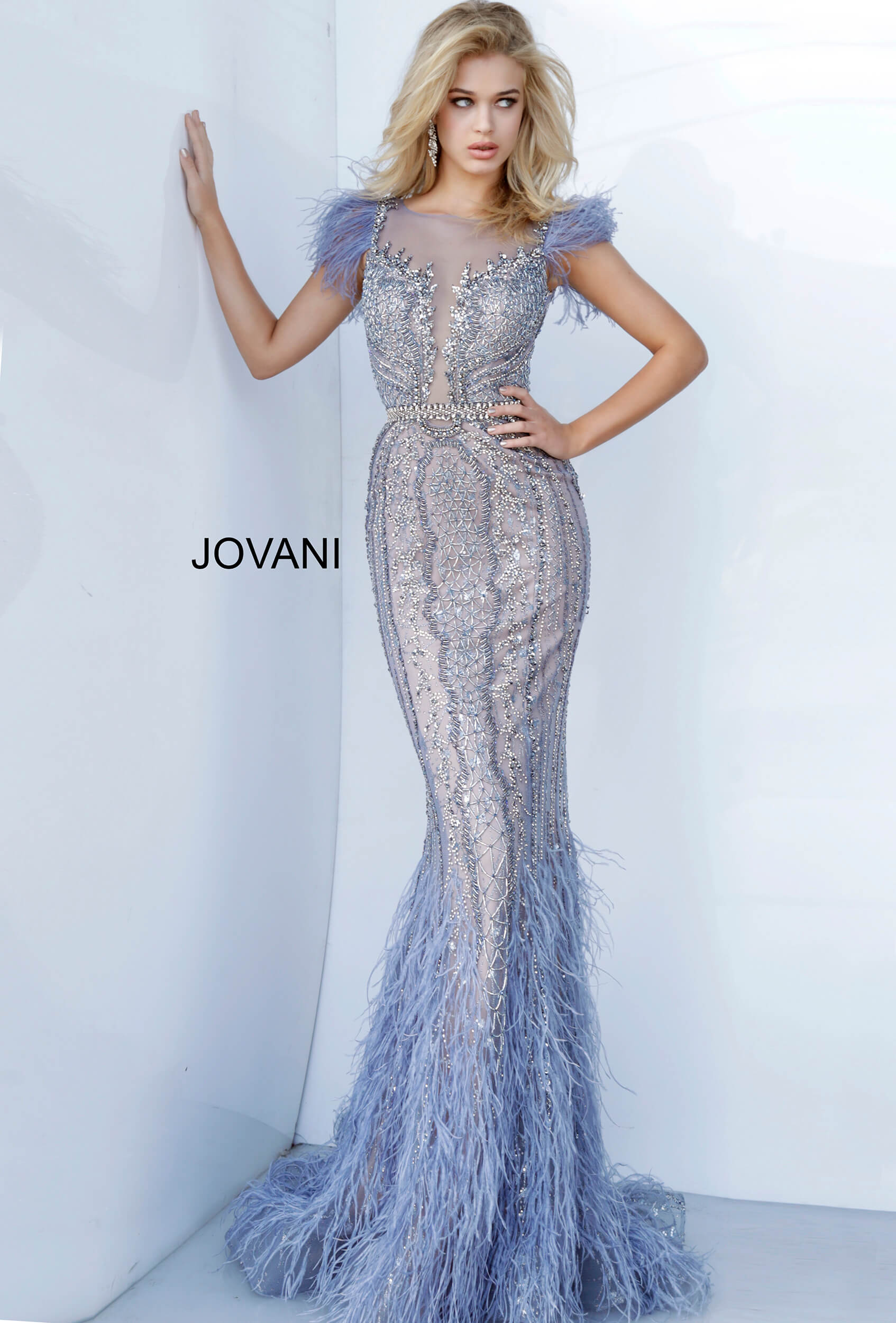 Jovani Couture 02326 is a long fitted Formal Evening Gown Great For Pageants, Red Carpet Events, Event Guests & More! Fit & Flare Mermaid silhouette with a sheer Illusion high neckline with a plunging effect with mesh trimmed in Embellishments that cascade into the bodice. Hand Beaded with sequin, liquid beading, Beaded Fringe tassels & rhinestones. Vintage blue embellished evening dress with a sheer illusion boat neckline, feather trim cap sleeves, beaded waist belt and closed sheer back.