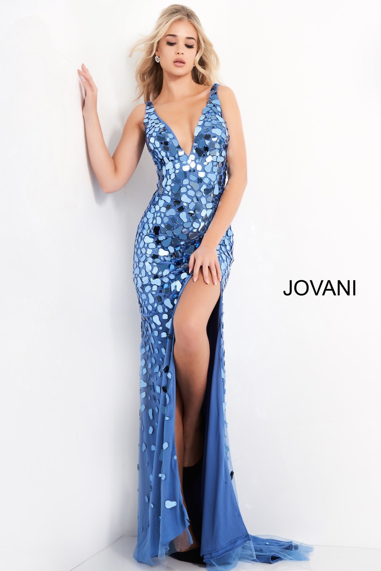 Jovani 02479 is a long sheath silhouette with a high slit. Deep V Neckline with sheer side mesh panels.  Cut Glass Embellishments cluster along the bodice and disperse as they cascade into the nude skirt.  Sexy Evening Gown Flashy Couture Cut Glass Prom & Pageant Dress. Formal Evening Gown.   Available Colors: Emerald, Nude, Perri  Available Sizes: 00-24