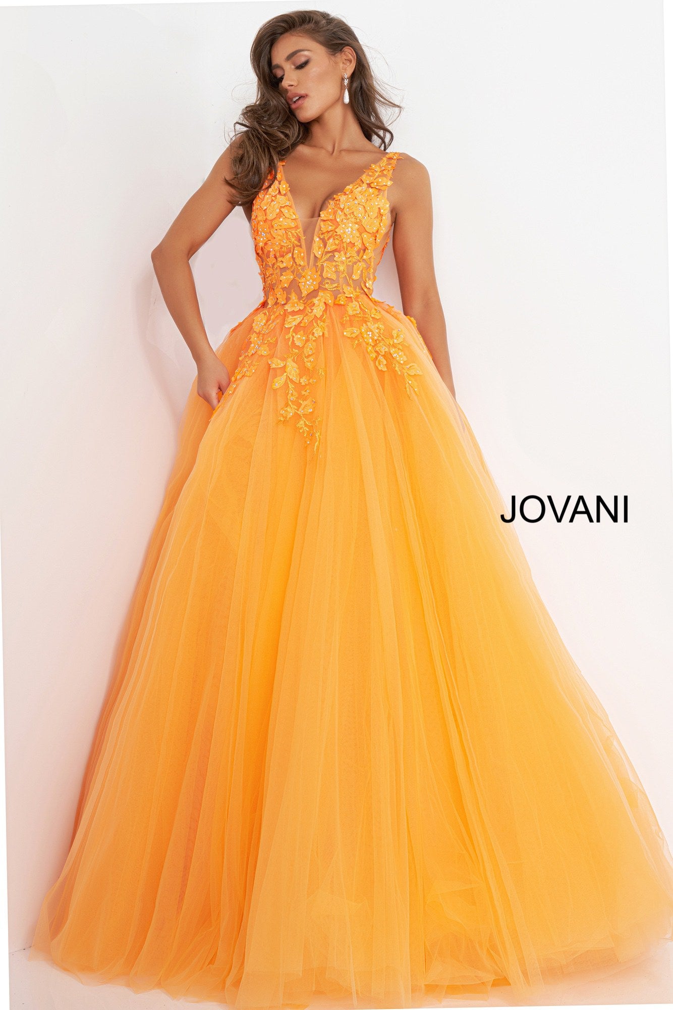 Jovani 02840 is a Gorgeous Lush A Line Tulle Ballgown Prom Dress. This Formal Evening Gown features a sheer v neckline fitted bodice with sheer side panels & mesh inserts. Open V Back. The Bodice is Covered in Embellished 3D Floral Lace Appliques cascading down into the full Ball Gown skirt. Great wedding Dress in Ivory with sweeping train.  Available Sizes: 00,0,2,4,6,8,10,12,14,16,18,20,22,24  Available Colors: black, dark blush, ivory, orange