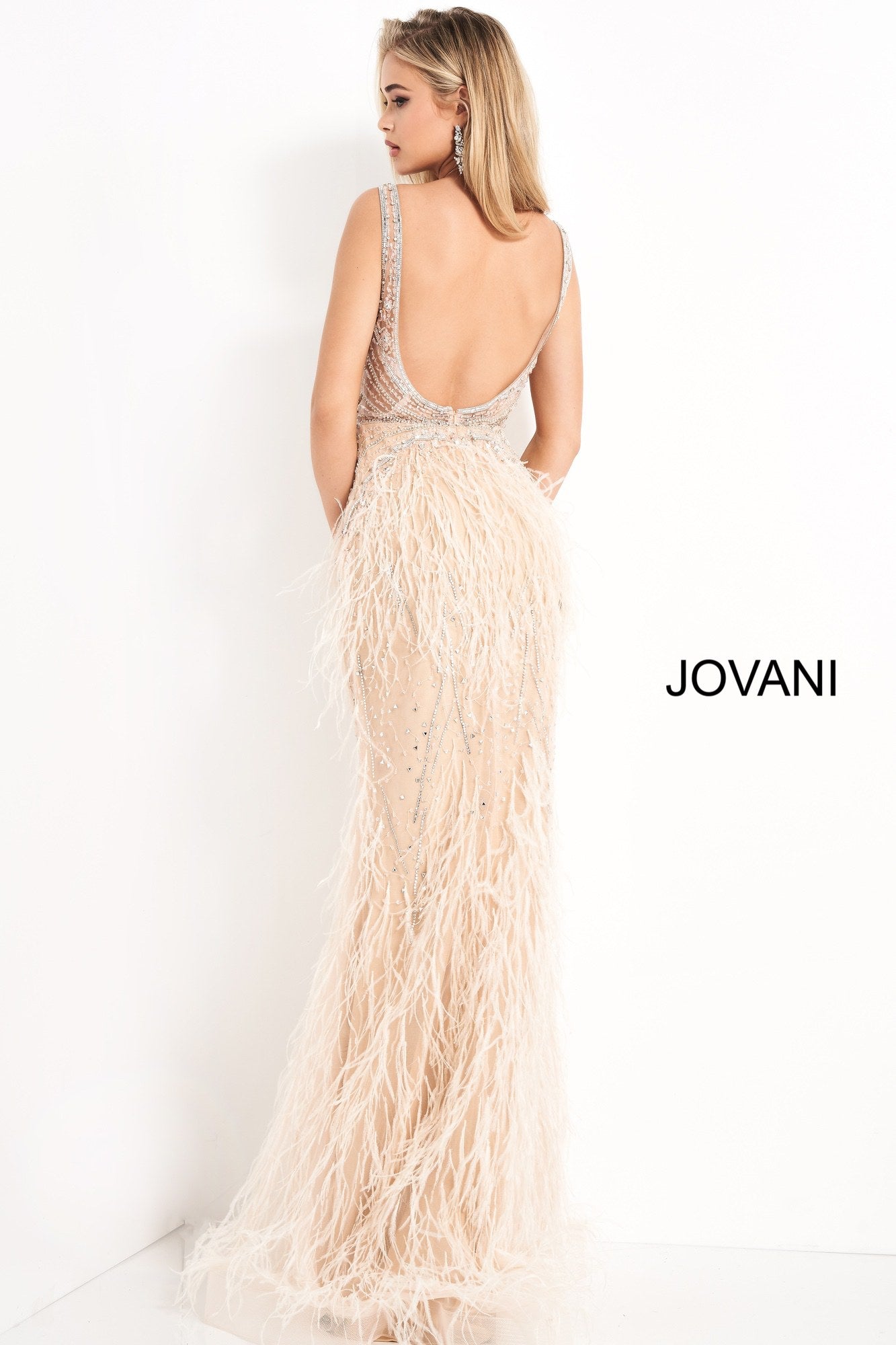 Jovani 03023 is a 2021 Prom Dress, Pageant Gown, Wedding Dress & Formal Evening wear. This Sheer embellished bodice features a plunging v neckline with beading & crystal accents cascading through a feather embellished skirt. Very stunning and unique wedding dress!   Available Colors: Off White, Blush, Black  Available Sizes: 00-24